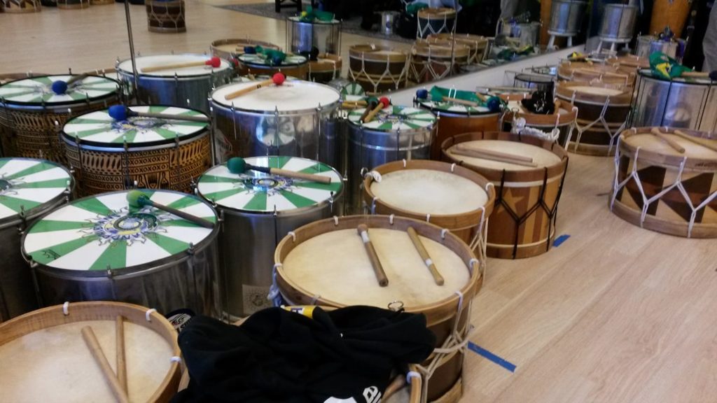 Many wooden drums next to a mirror